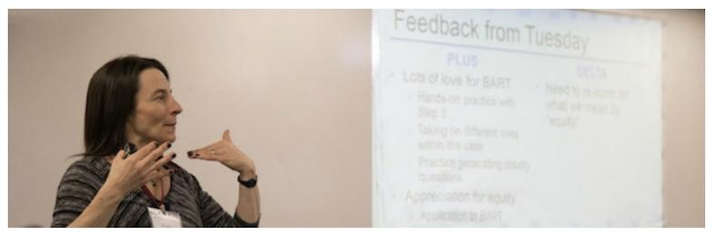 Person presenting in front of a projector