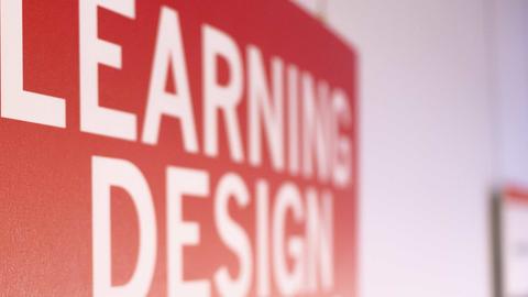 Poster on a wall with a focus on the text "Learning Design"